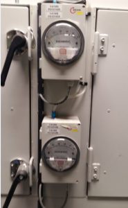 A differential pressure gauge installed in the vents or hoods.